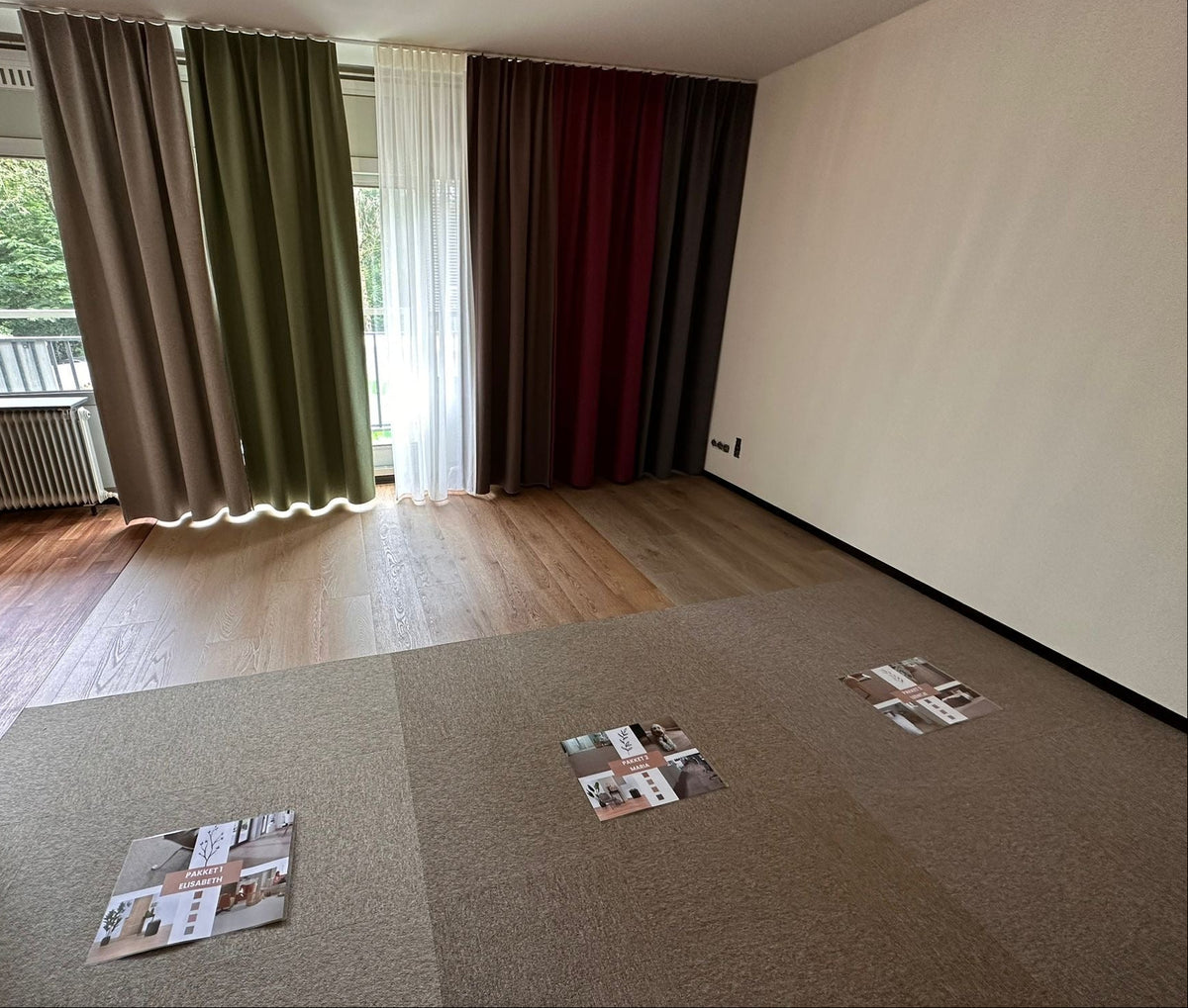 Lege kamer met houten vloer, tapijttegelstalen en gordijnstalen in diverse kleuren
